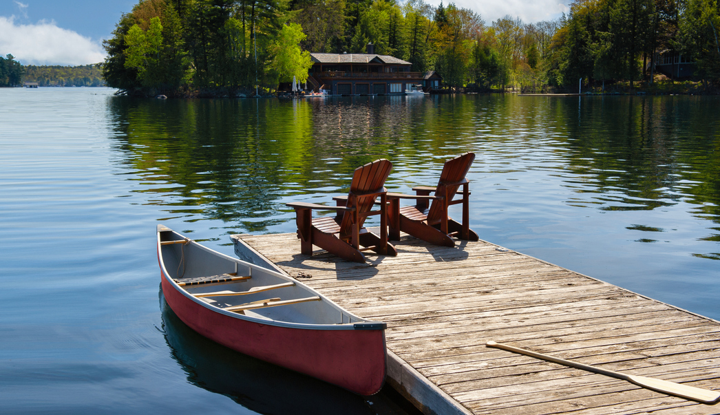 Lake dock with chairs and a canoe.